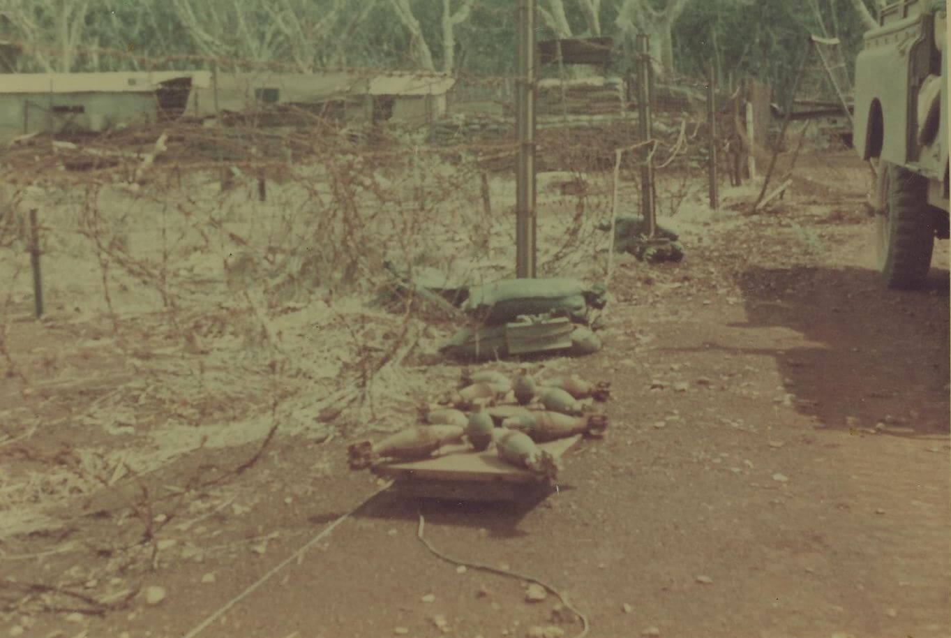 At the scene of a mine incident.  An M16 mine that had been lifted from the Barrier Minefield and placed on the track near the minefield has detonated when a D6 bull dozer ran over it.  Dat Do 1969.
